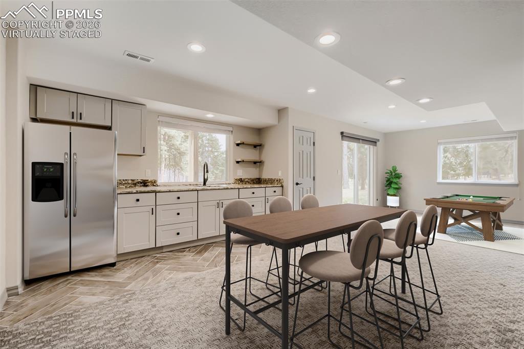 Image 37 of 48: Virtually staged wet bar and game room