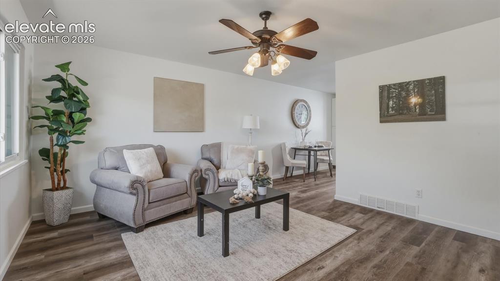 Image 20 of 48: The Living Room flows seamlessly into the Dining Area and Kitchen.