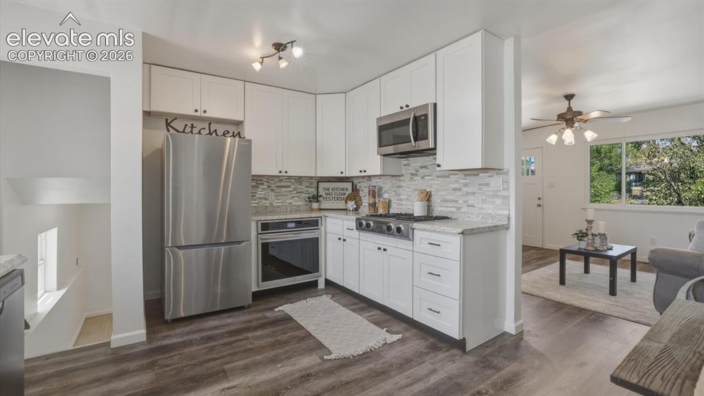 Image 25 of 48: Stainless steel appliances include a gas cooktop, oven, microwave, dishwash