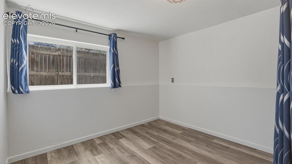 Image 32 of 48: Lower Level Bedroom #4 with bamboo flooring.