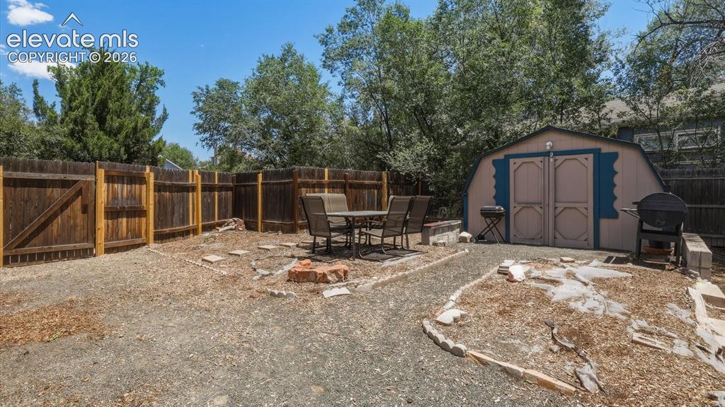 Image 36 of 48: Storage shed for tools, toys, and recreational gear.