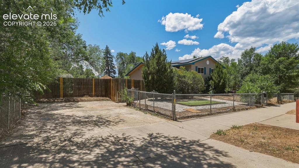 Image 37 of 48: Concrete driveway for off street parking or RV storage.
