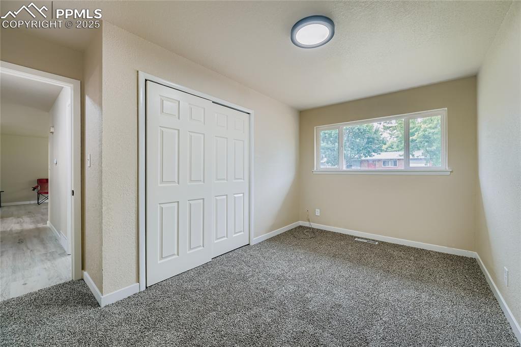 Image 10 of 25: Unfurnished bedroom featuring a closet and carpet