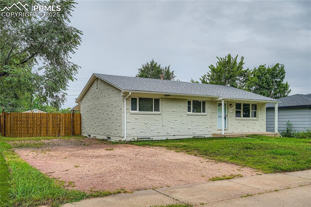 Image 2 of 25: Ranch-style house with brick siding, roof with shingles, and crawl space