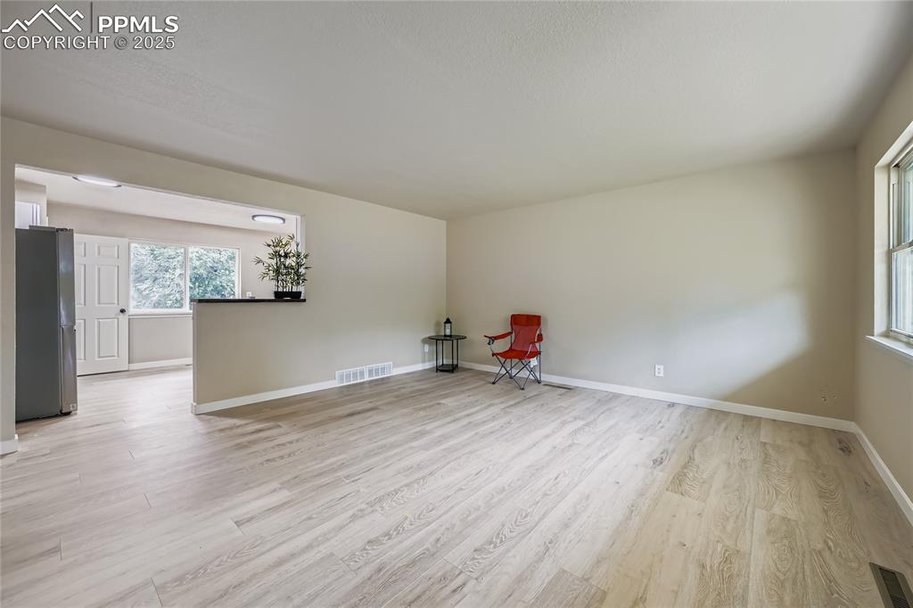 Image 8 of 25: Empty room featuring light wood-type flooring
