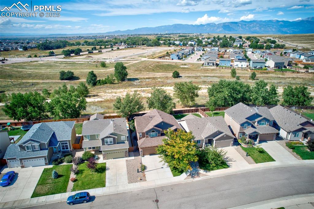 Image 2 of 39: Aerial view of residential area featuring a mountainous background