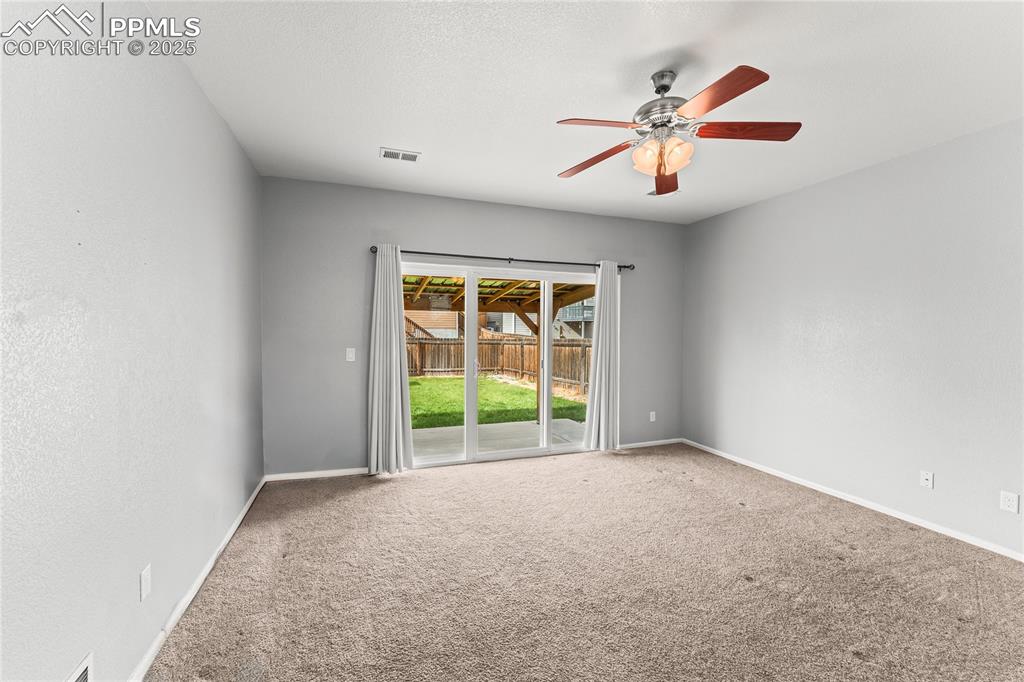 Image 11 of 39: Carpeted spare room featuring a ceiling fan and a textured ceiling