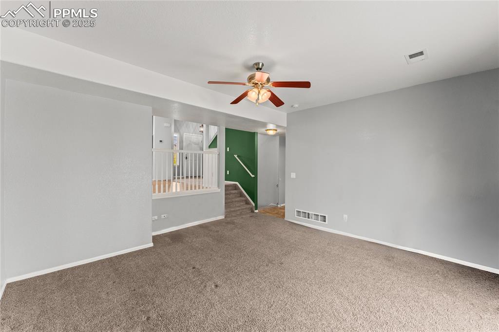 Image 13 of 39: Carpeted spare room featuring baseboards and ceiling fan