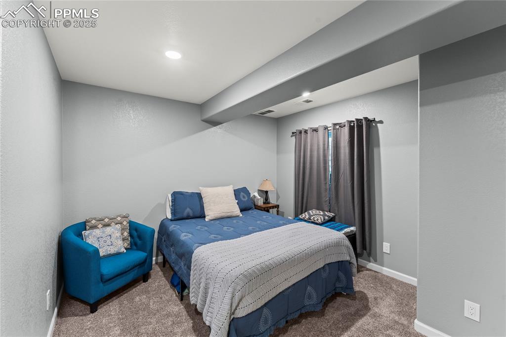 Image 20 of 39: Bedroom with carpet and a textured wall