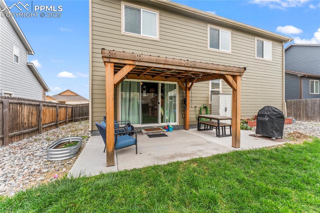 Image 37 of 39: Rear view of property featuring a patio area and a fenced backyard