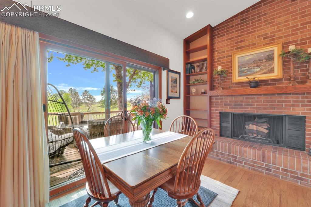 Image 10 of 42: Dining are with walk-out to deck and wood-burning fireplace