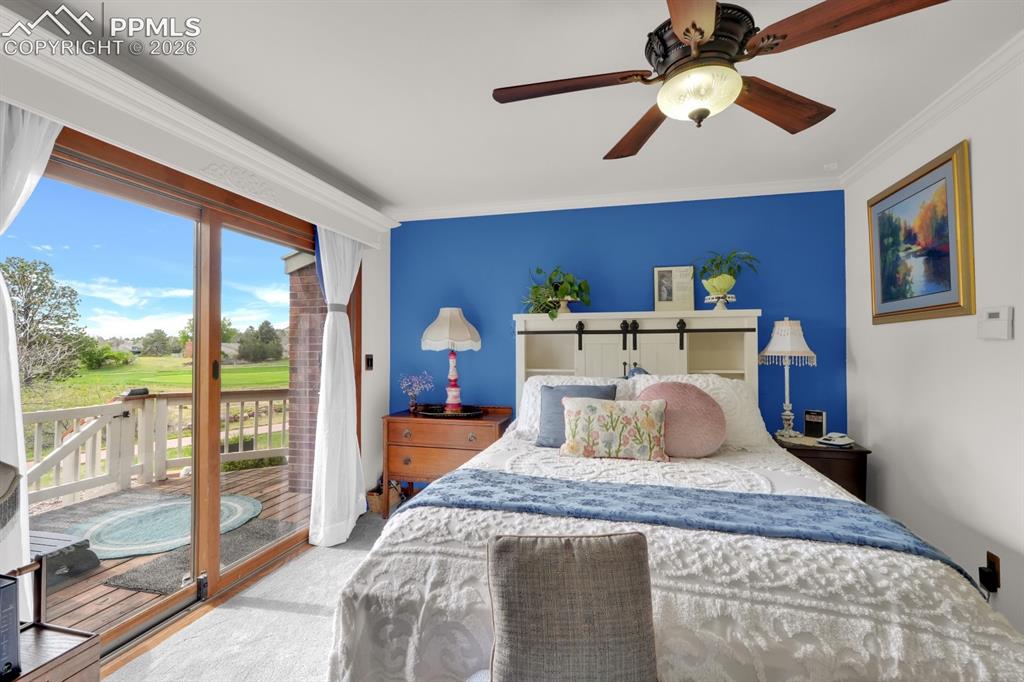 Image 16 of 42: Primary bedroom with walk-out to deck