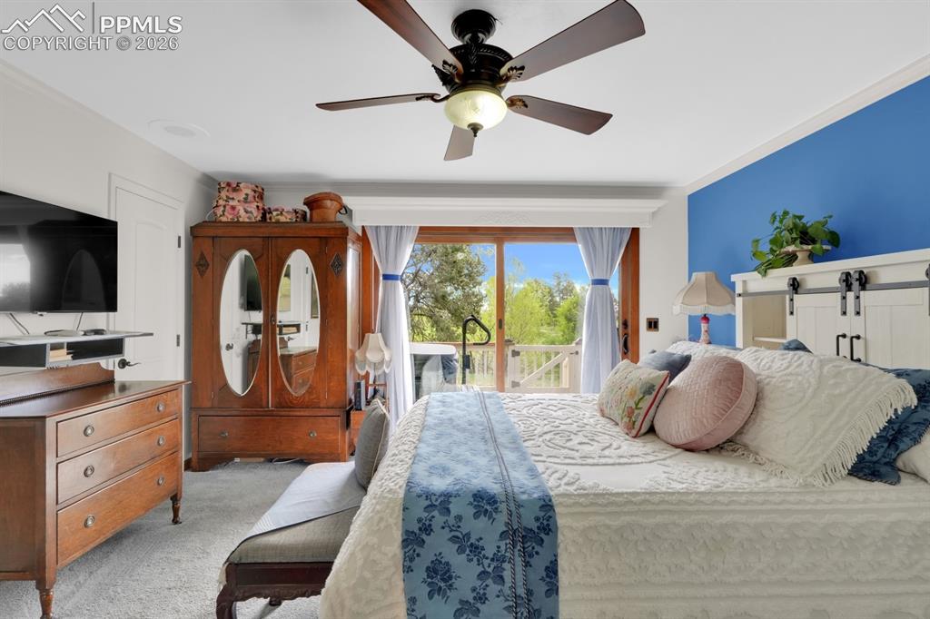 Image 17 of 42: Primary bedroom with walk-out to deck