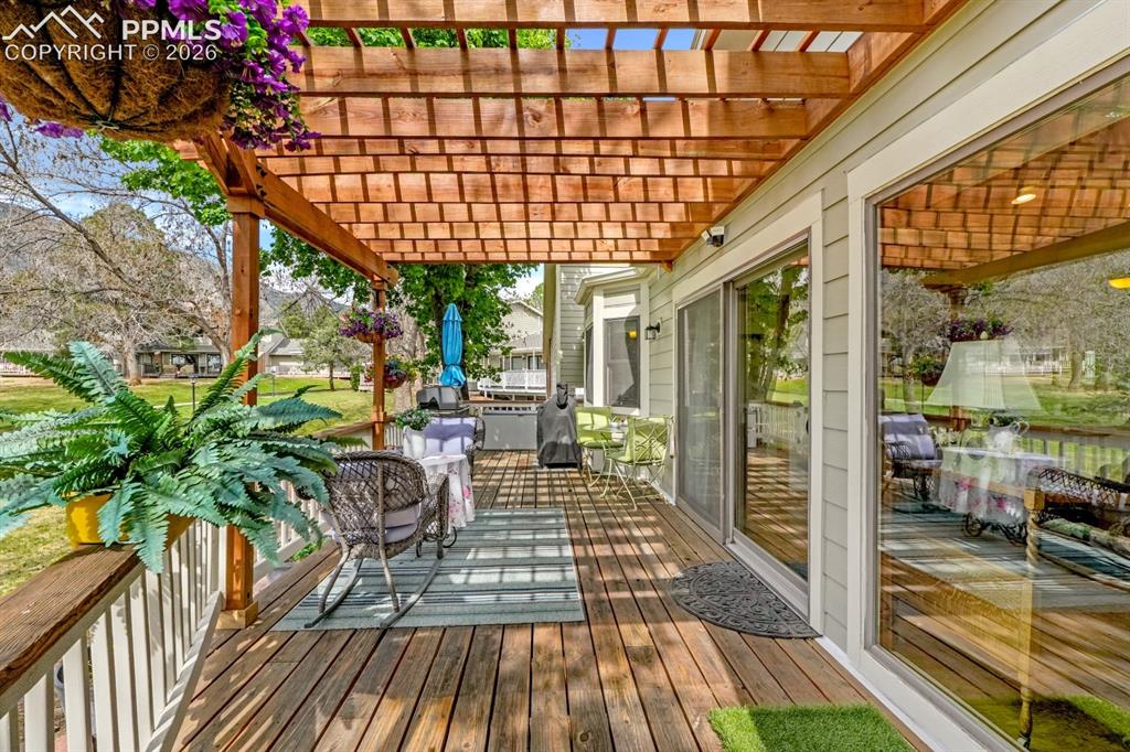Image 27 of 42: Wrap around deck with pergola