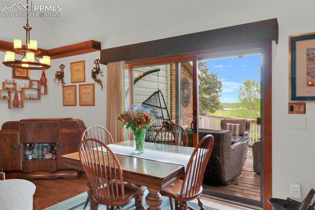 Image 9 of 42: Dining are with walk-out to deck
