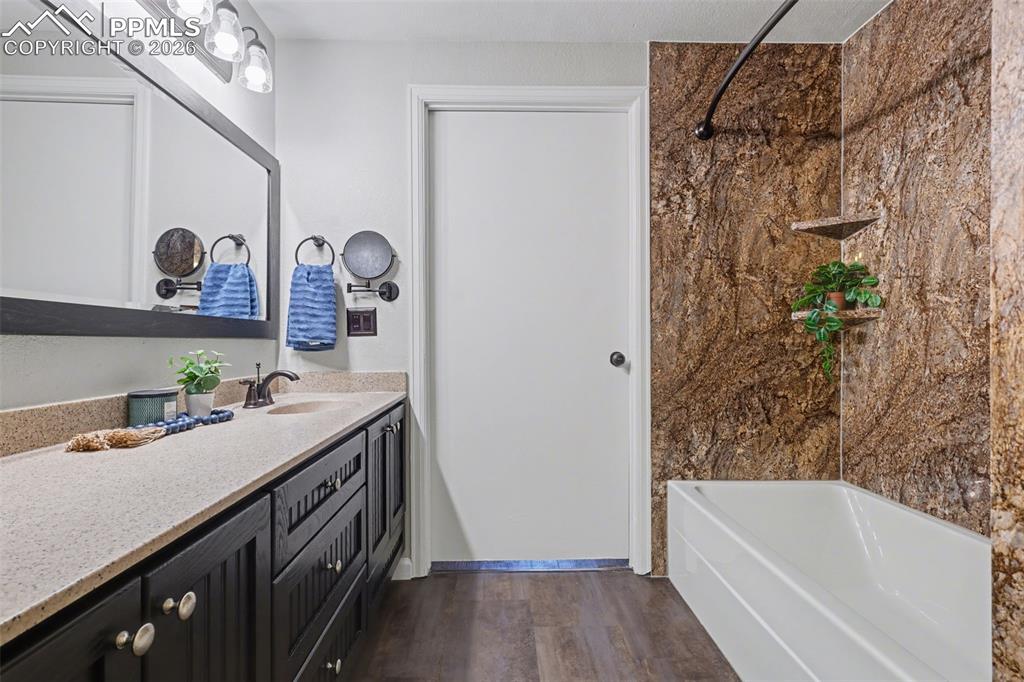 Image 19 of 31: Full bath that shows entry door into bdrm 3