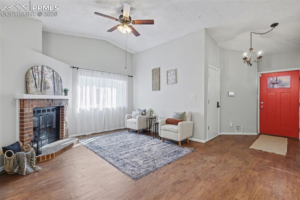 Image 5 of 31: Living room looking back towards front door and garage access door