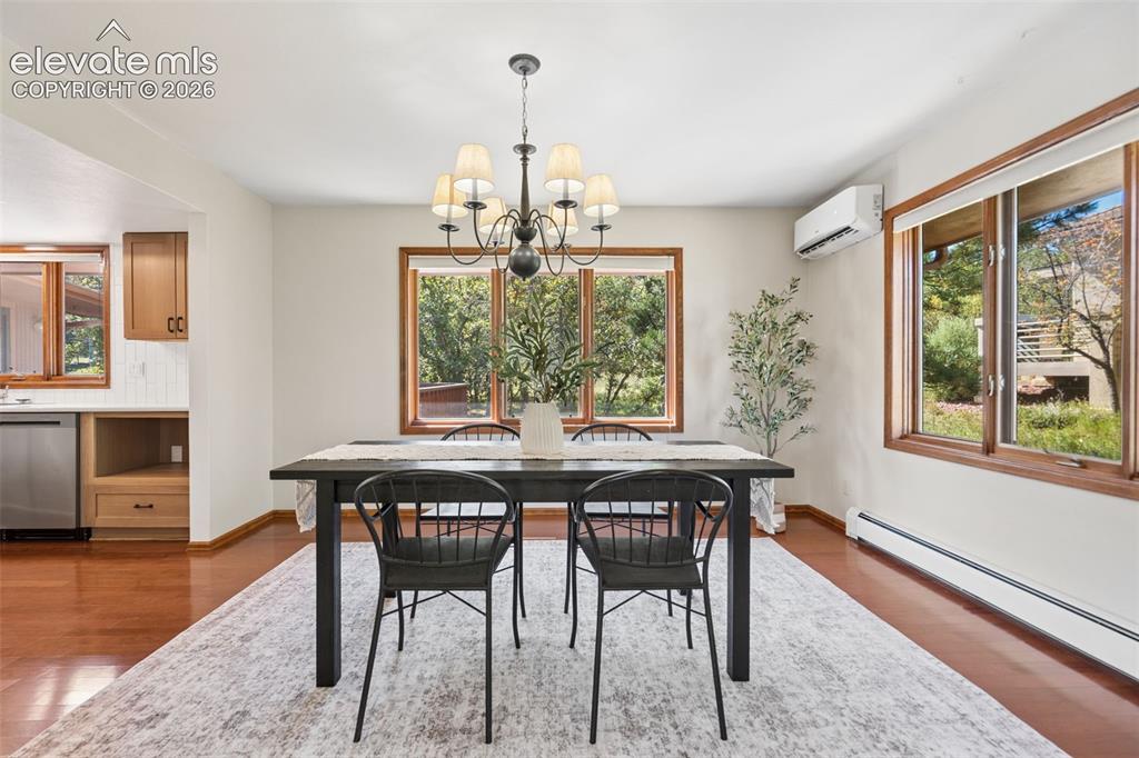 Image 17 of 50: Hardwood flooring, natural wood window trim, stainless steel dishwasher, bu