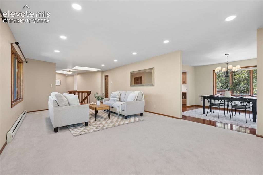 Image 20 of 50: Recessed lighting, wood-finish window trim, and a skylight illuminate this