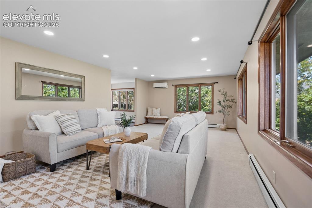 Image 21 of 50: Recessed ceiling lighting, numerous windows with wood-finish frames, light-
