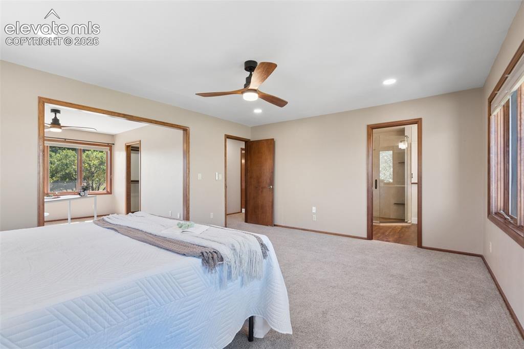 Image 25 of 50: Recessed lighting, wood-finish trim, and ceiling fans