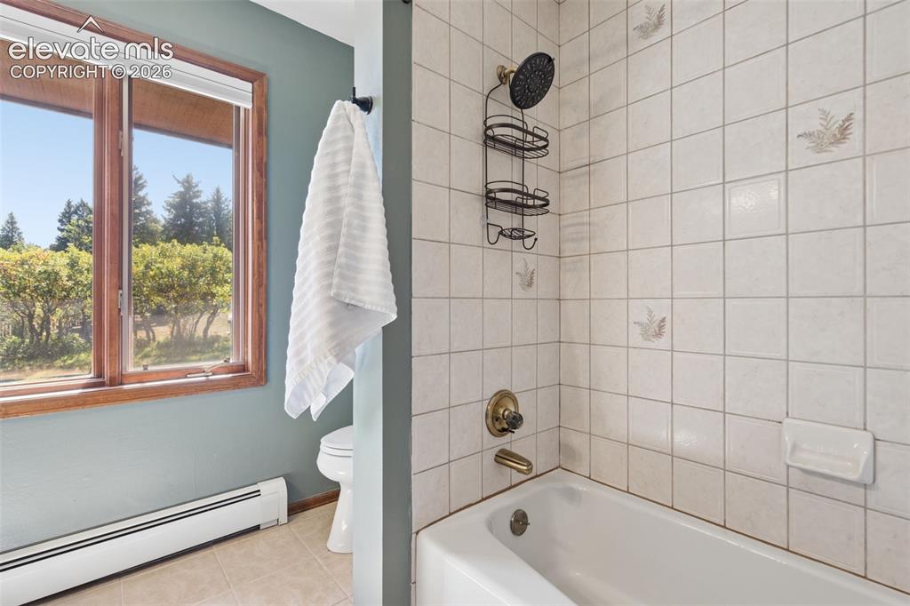 Image 32 of 50: White tiled shower and tub combination