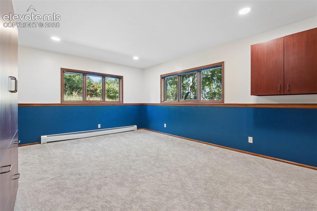 Image 42 of 50: Recessed lighting, wood-trimmed windows, wall-mounted cabinetry, built-in b