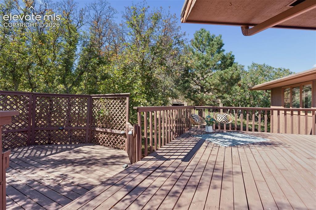 Image 45 of 50: Expansive wood deck with a full railing system