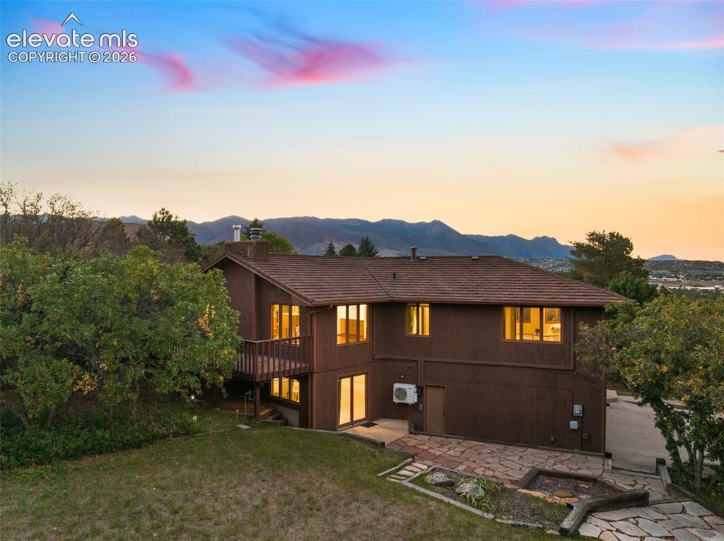 Image 50 of 50: Multi-level residence featuring a dark wood exterior, a brown shingle roof,