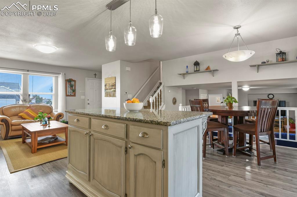 Image 10 of 31: Kitchen featuring an open concept to the living room and see through to the