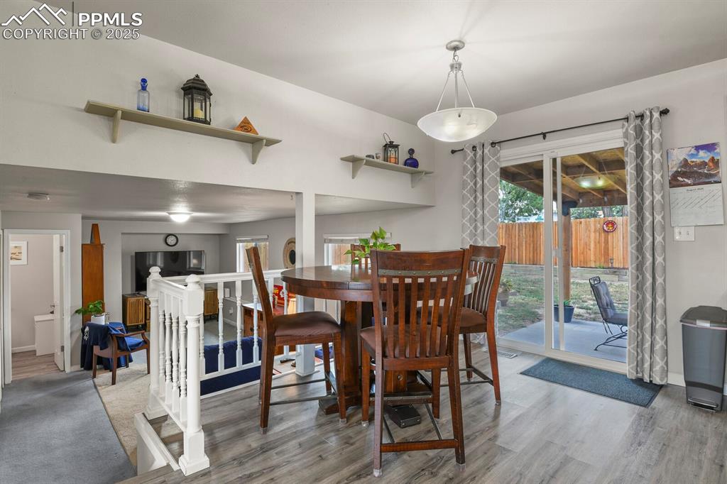 Image 11 of 31: Dining room area, open to the kitchen and see through to the lower level, a