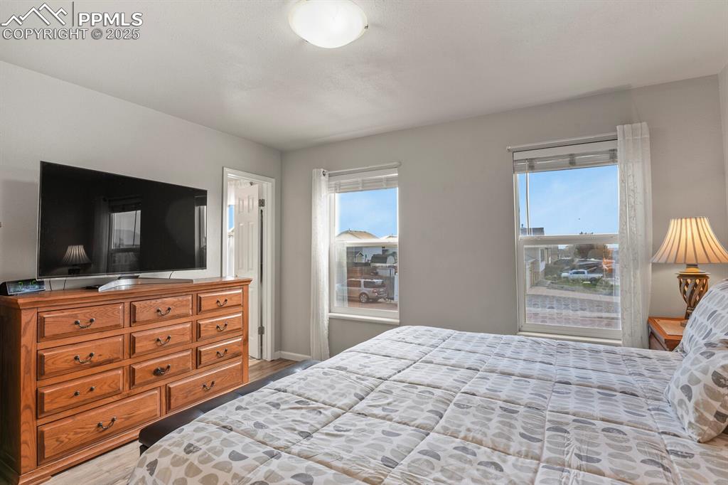 Image 14 of 31: Primary bedroom with two nice windows and an ensuite bathroom