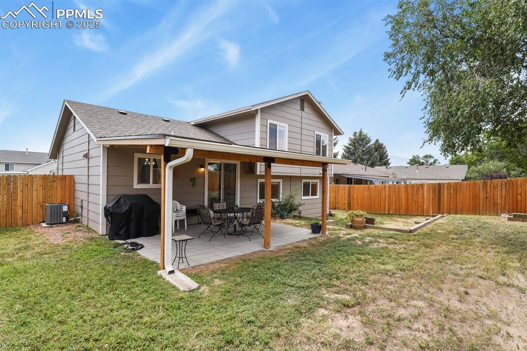 Image 25 of 31: Back of property with a fenced backyard and a nice patio with new patio roo