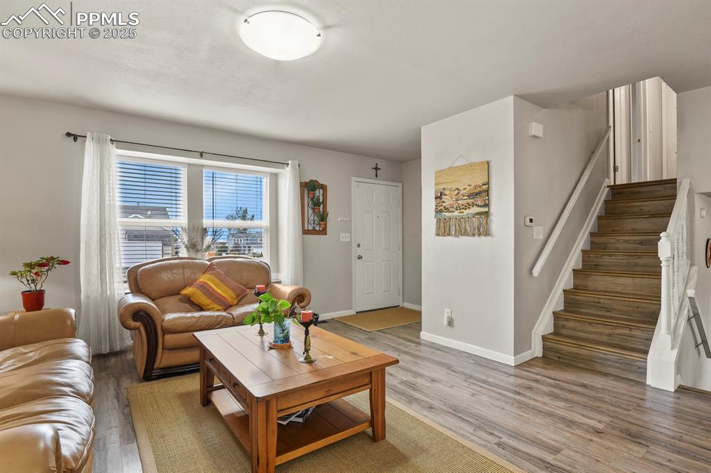 Image 5 of 31: Living room featuring nice window and vinyl wood-style flooring