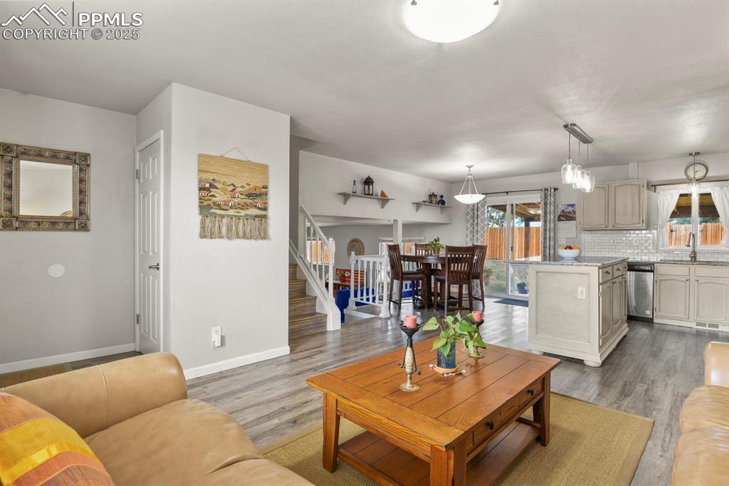Image 6 of 31: Open concept living featuring the main level living room, kitchen and dinin
