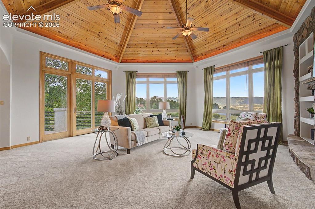 Image 17 of 50: Vaulted wood-paneled ceiling with recessed lighting and ceiling fans