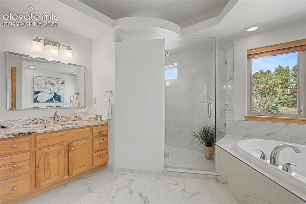 Image 23 of 50: Bathroom featuring a spacious walk-in shower with clear glass enclosure and
