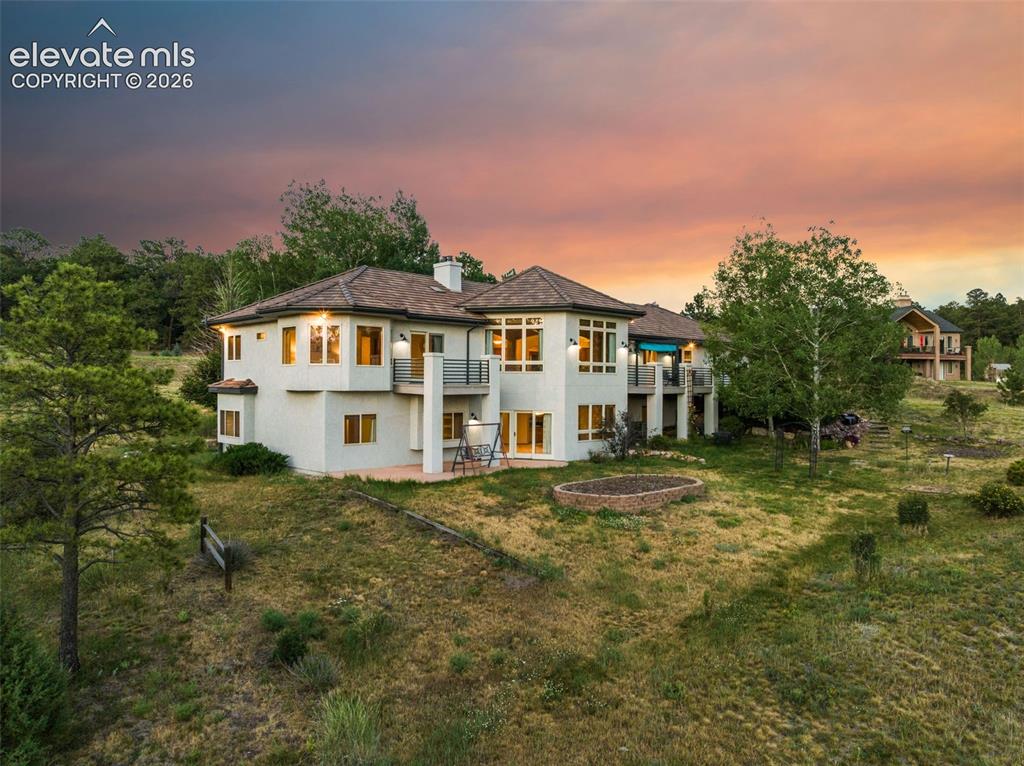 Image 3 of 50: Multi-level stucco exterior residence featuring a composite shingle roof, m