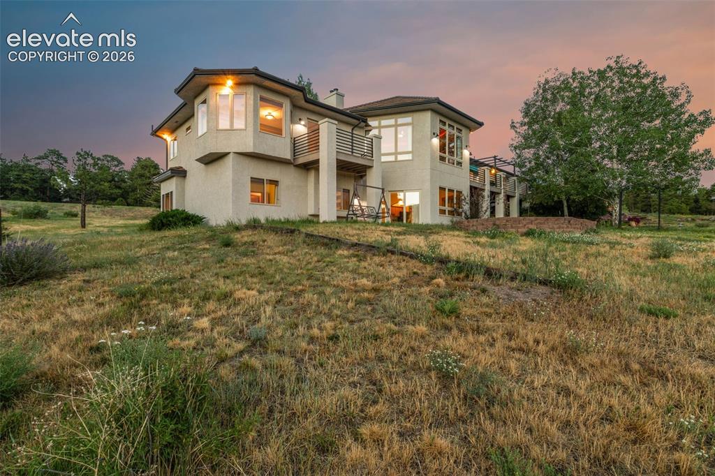 Image 4 of 50: Multi-level stucco exterior with multiple windows and balconies