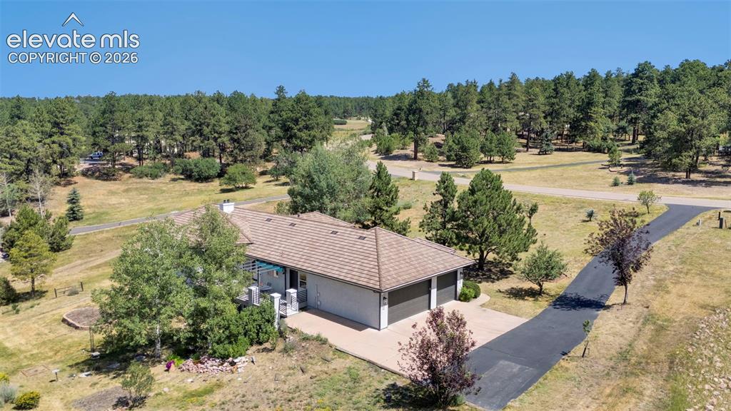 Image 47 of 50: Ranch-style residence featuring an attached two-car garage and a paved driv