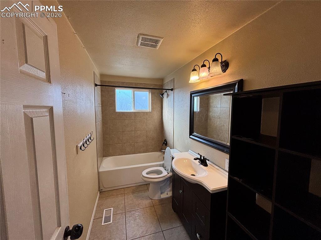 Image 9 of 27: Bathroom #1 with Black Shelving Unit