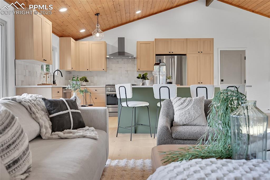 Image 16 of 40: Living area with wooden ceiling, recessed lighting, and high vaulted ceilin