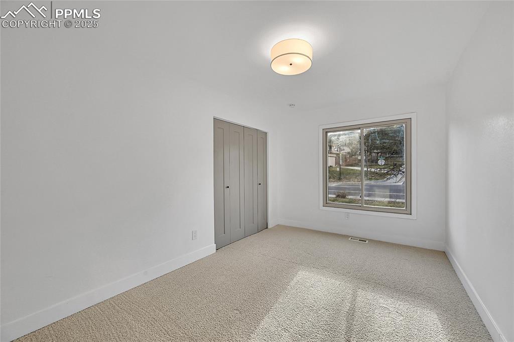 Image 27 of 40: Carpeted empty room with baseboards