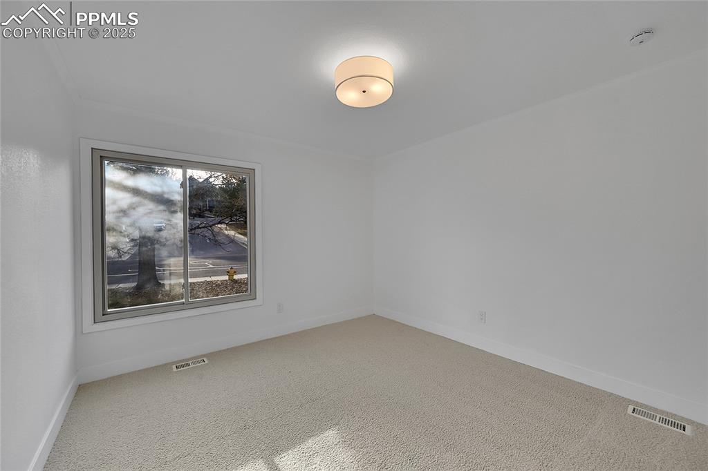 Image 30 of 40: Spare room featuring carpet floors and baseboards