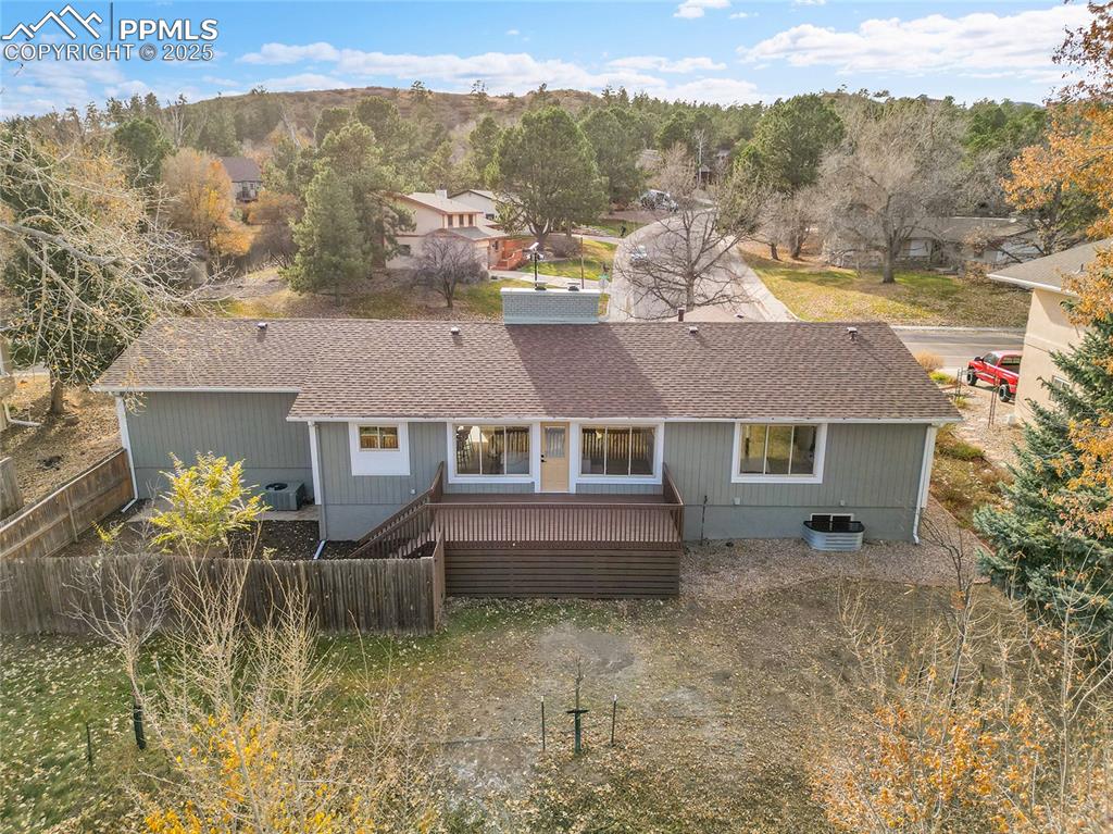 Image 36 of 40: Back of house featuring roof with shingles, a deck, and stairway
