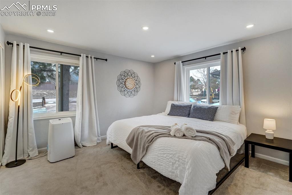 Image 12 of 31: Primary main level bedroom with views of the front range.