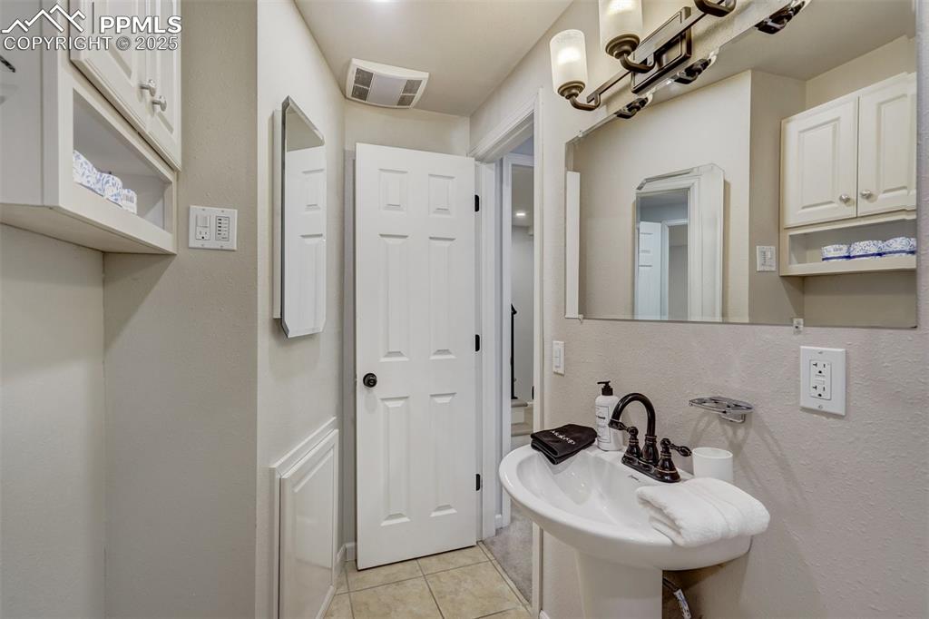 Image 24 of 31: Bathroom with light tile patterned floors