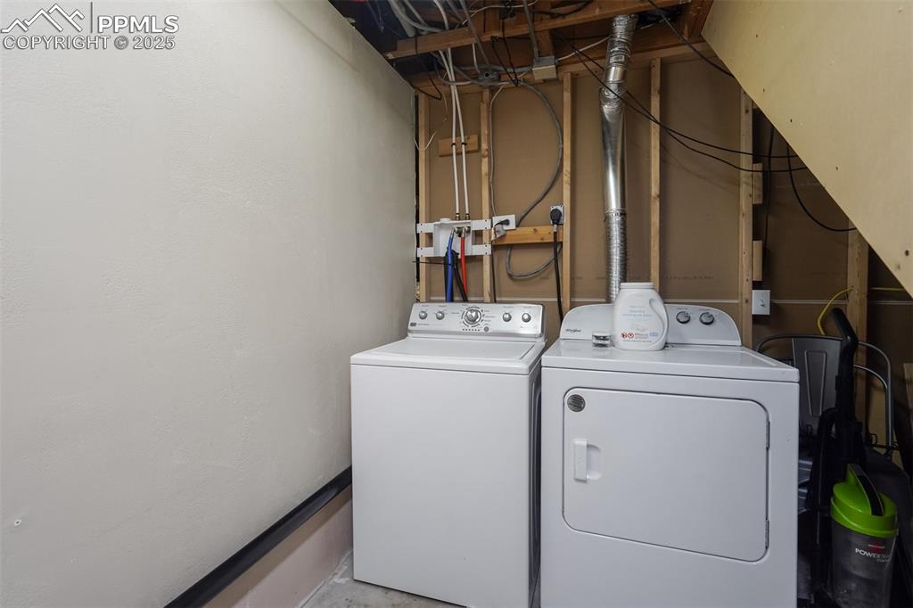 Image 25 of 31: Basement laundry area featuring washer and dryer
