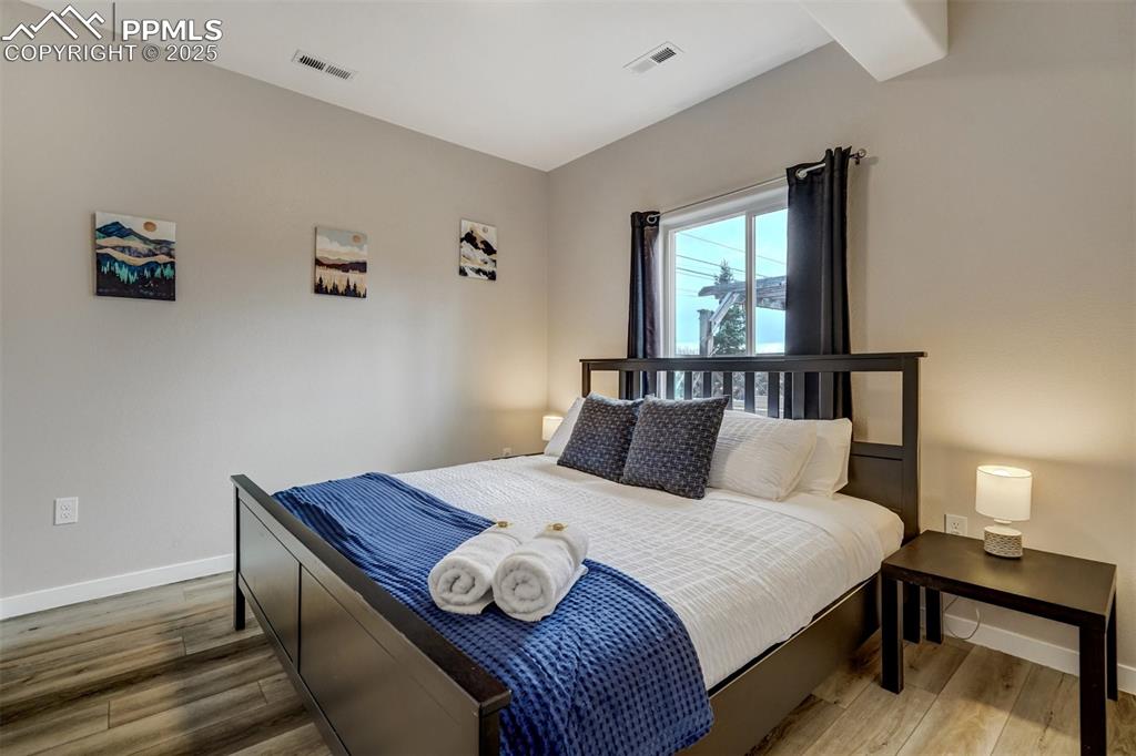 Image 27 of 31: Cottage - Primary bedroom with LVP floors.