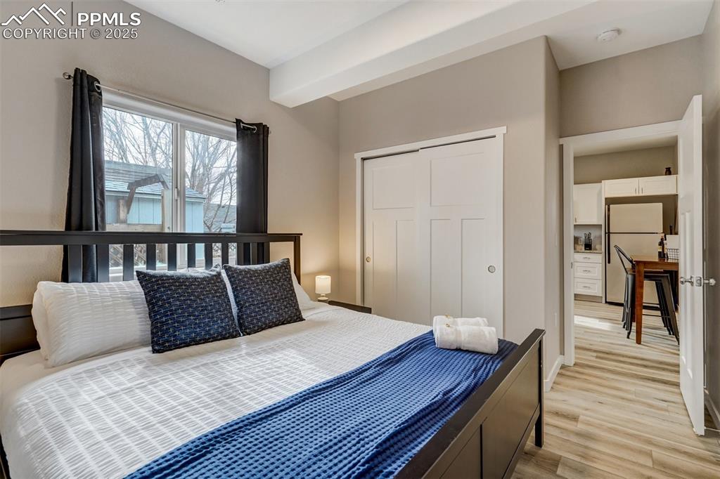 Image 28 of 31: Cottage - Primary bedroom with light wood-style floors, a closet, and frees